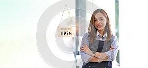 Startup successful small business owner sme girl stand with tablet smartphone in coffee shop restaurant. Portrait of asian