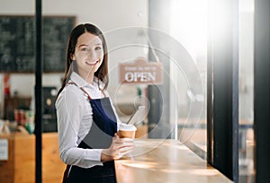 Startup successful small business owner sme woman stand with tablet  in cafe restaurant