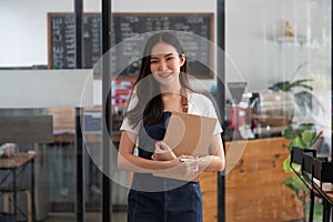 Startup successful small business owner woman beauty girl standing in coffee shop restaurant. Portrait of smiling asian