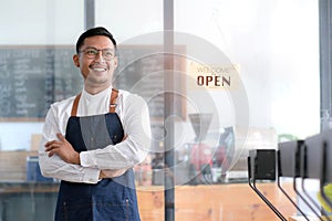 Startup successful small businessman owner sme stand with tablet smartphone in coffee shop restaurant. Portrait of asian