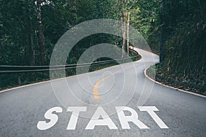 Startup to success business printed on road leading toward