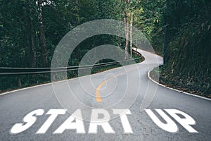 Startup to success business printed on road leading towards