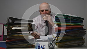 Starved Businessman  Working with Files in Archive Room Eating a Tasty Sandwich