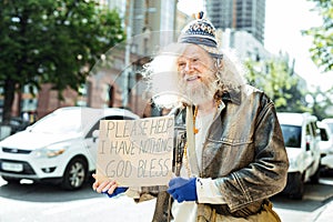 Starving fugitive asking for help standing in the street