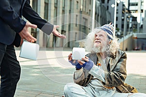 Starving fugitive feeling happy while getting food box