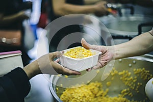 Starving homeless people receive food from volunteers who serve humane: the concept of giving with care