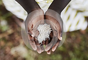 Starving Hunger Symbol Black African Boy Holding Rice Malnutrition. Stop hunger in the world! photo