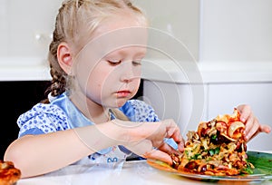 Starving young girl eating