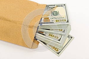 Stash of money in hundred dollar banknotes coming out of envelope