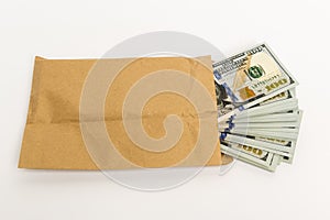 Stash of money in hundred dollar banknotes coming out of envelope