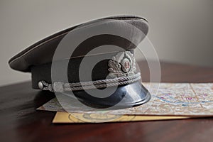 Stasi officer cap on a map of Berlin