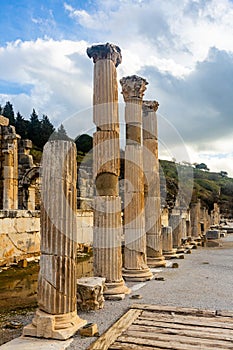 State Agora columns in ancient Ephesus with Odeon ruins in background