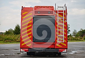 A state-of-the-art firetruck, equipped with advanced rescue technology, stands ready with its skilled firefighting team