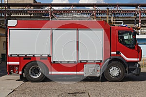 A state-of-the-art firetruck, equipped with advanced rescue technology, stands ready with its skilled firefighting team