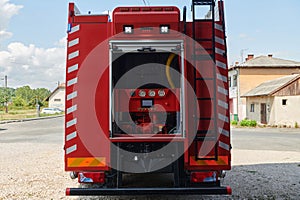 A state-of-the-art firetruck, equipped with advanced rescue technology, stands ready with its skilled firefighting team