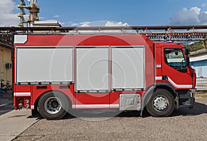 A state-of-the-art firetruck, equipped with advanced rescue technology, stands ready with its skilled firefighting team