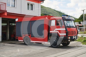 A state-of-the-art firetruck, equipped with advanced rescue technology, stands ready with its skilled firefighting team