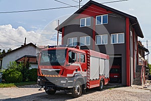 A state-of-the-art firetruck, equipped with advanced rescue technology, stands ready with its skilled firefighting team