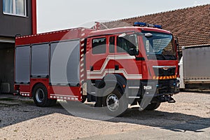 A state-of-the-art firetruck, equipped with advanced rescue technology, stands ready with its skilled firefighting team