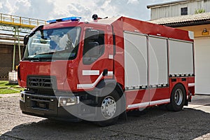 A state-of-the-art firetruck, equipped with advanced rescue technology, stands ready with its skilled firefighting team