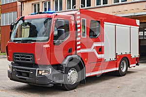 A state-of-the-art firetruck, equipped with advanced rescue technology, stands ready with its skilled firefighting team