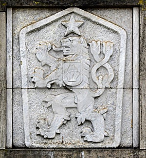 State emblem, symbol of communist Czechoslovakia, a two-tailed lion with a five-pointed star, Hussite shield in the background