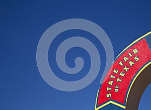 A State Fair of Texas sign and blue sky background