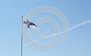 State flag of Finland flies from a flagpole