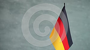 State flag of Germany waving on gray background. Bundesrepublik Deutschland flag and place for text