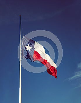 State flag of Texas flying at half-mast
