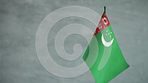 State flag of Turkmenistan waving on light background. Turkmenian flag and place for text