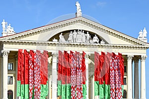 State flags of the Republic of Belarus against the backdrop of the Palace of Culture of Trade Unions in Minsk