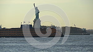 Staten Island Ferry passing Statue of Liberty in New York City. Famous Landmark