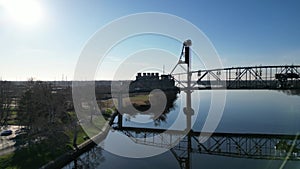 Static drone aerial view of a truss vehicle bridge with cars and truck traffic going over it