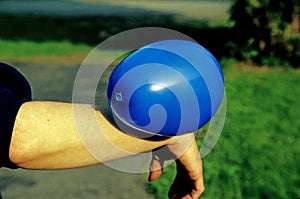 Static electricity shown by balloon attached to female arm photo