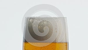 Static foamy beer goblet white background. Bubbled alcohol drink texture closeup