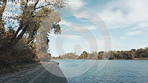 Static shot on the sandy shore of the sacramento river in fall