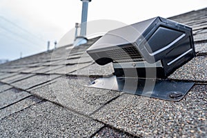 Static vent installed on a shingle roof for passive attic ventilation photo