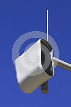 Static speed or safety camera against a blue sky