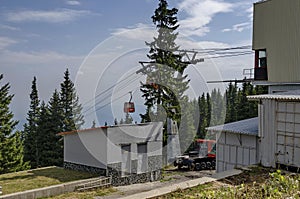 Station of contemporary ski tow or lift in sunny day with blue sky near by hija or rest-house Aleko photo
