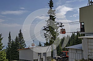 Station of contemporary ski tow or lift in sunny day with blue sky near by hija or rest-house Aleko, Cherni vrah photo