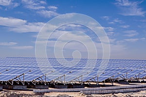 Station of solar panels in the desert against blue sky photo