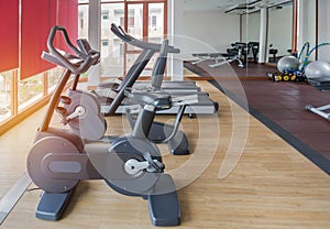 Stationary bikes and treadmills equipment health exercise in fitness center room