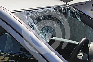 Stationary car with broken windshield. Car windscreen smashed by a thief. Automobile broken window. Theft from the car. A criminal