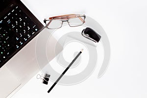 Stationary concept, Flat Lay top view Photo of laptop, pencil, stapled, paper clips, eyepieces, notes on white background with cop