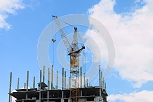 Stationary hoist on construction site, part of building