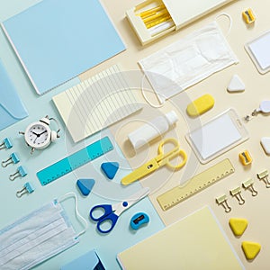 Stationary school supplies in yellow and blue tone. Office accessories and personal protective equipments