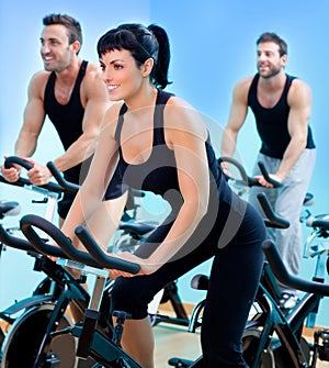 Stationary spinning bicycles fitness girl in a gym