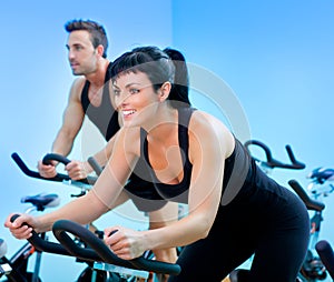 Stationary spinning bicycles fitness girl in a gym