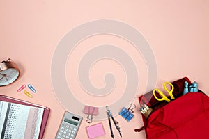 Stationeries and office supplies on pink background. Flat lay. Top view with copy space. Back to school concept. photo